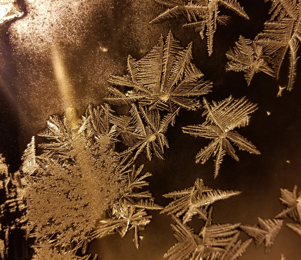 Abstract shot of snow formed, fallen and frozen in perfect shape on a winshield in the freezing cold