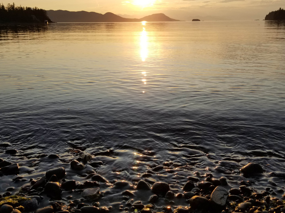 Scenic landscape shot of the sun setting on Ealge Beach in Juneau Alaska